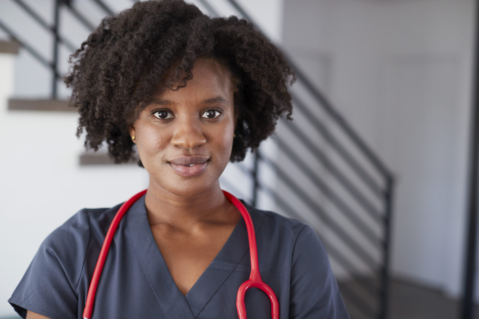 Portrait Of Female Nurse Wearing Scrubs In Hospital